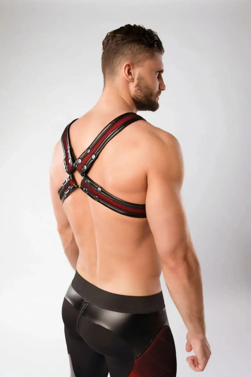 Maskulo Armored Color-Under red mesh chest X-harness with black faux leather piping, perfect for fitness enthusiasts and party-goers