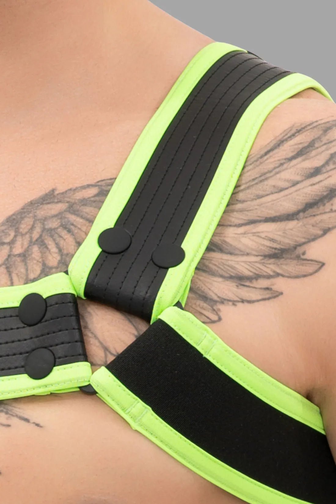 Outtox Bulldog Harness in Black/Neon Green. Features PU leather straps, snaps, and adjustable buckles for a bold, comfortable fetish look.
