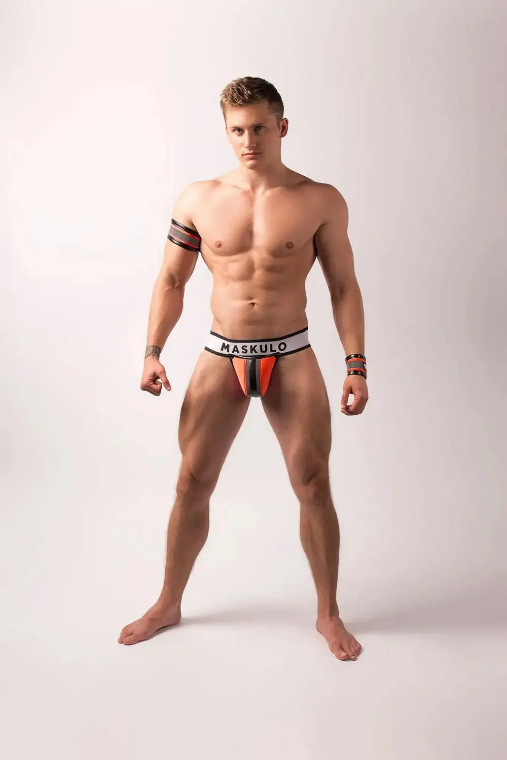 Maskulo neon orange fetish jockstrap with a big bulge detachable codpiece, shiny black leather-look piping, appealing to leather fetish and puppies subculture fans